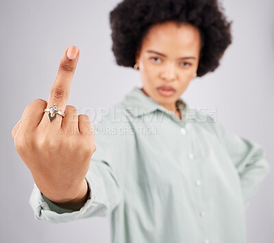 Buy stock photo Portrait of black woman, opinion and middle finger in studio, angry expression in conflict on isolated on white background. Fingers, rude hand gesture and offended, frustrated person in anger or hate