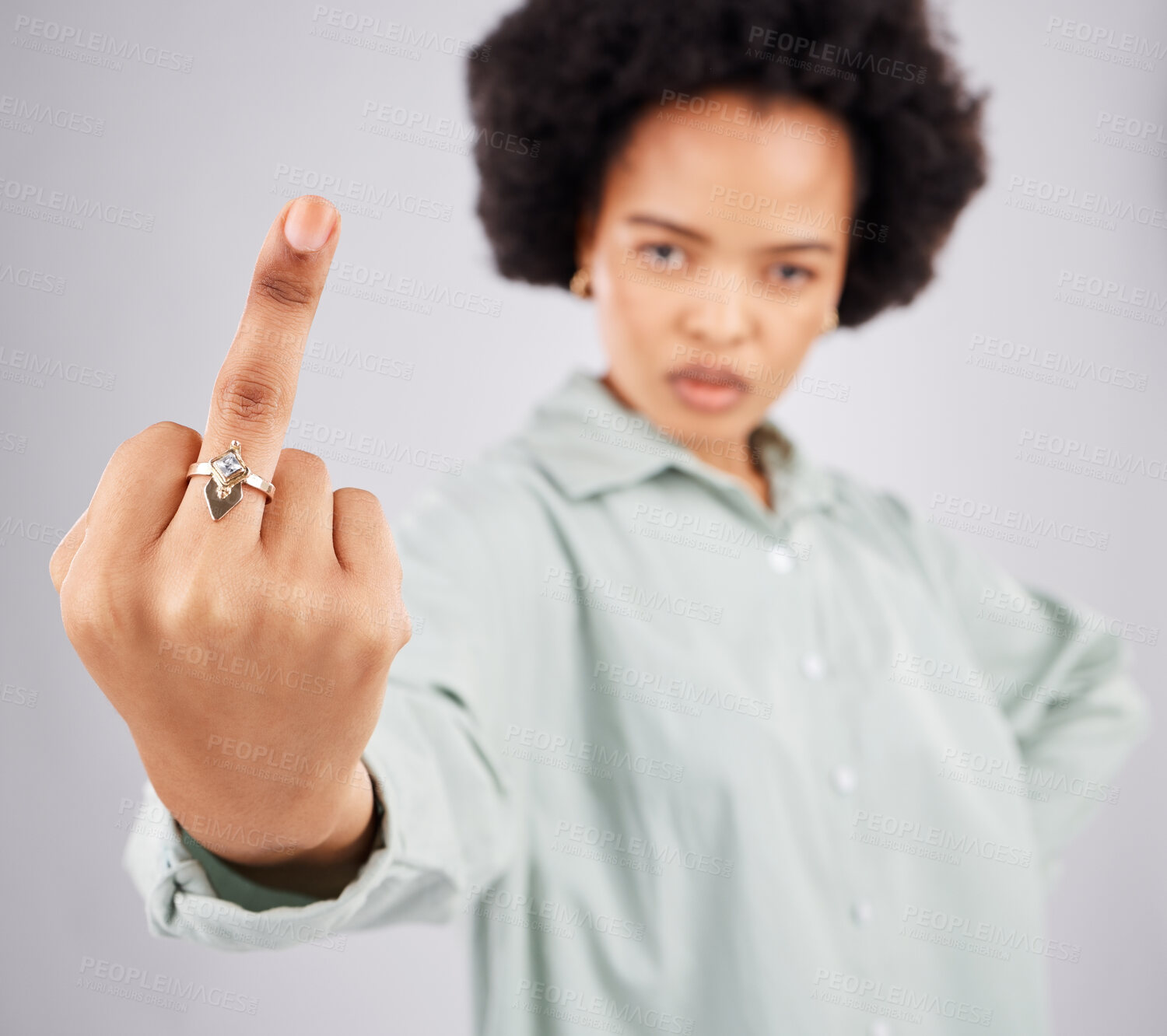 Buy stock photo Portrait of black woman, opinion and middle finger in studio, angry expression in conflict on isolated on white background. Fingers, rude hand gesture and offended, frustrated person in anger or hate