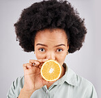 Portrait, orange and black woman fruit in studio isolated on a white background. Food face, nutritionist and serious person or female with vitamin c, nutrition or healthy diet, citrus or vegan detox.