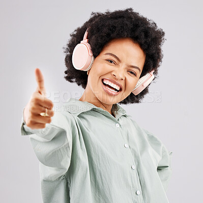 Buy stock photo Portrait, thumbs up and black woman with headphones in studio isolated on a white background. Success, funny and person with hand gesture, emoji or winning, agreement or like while streaming music.