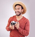 Travel, camera and happy asian man on holiday, adventure and photography on white background. Smile on face, tourism and Indian photographer or journalist on vacation, happiness on journey in studio.