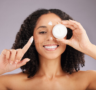 Buy stock photo Woman, face and smile for skincare cream or beauty against a gray studio background. Portrait of happy female smiling and holding cosmetic product in healthy skin, self care or facial treatment