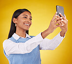 Happy, smile and selfie with woman in studio for social media, technology and internet post. App, online and picture with female on yellow background for happiness, connection and photography