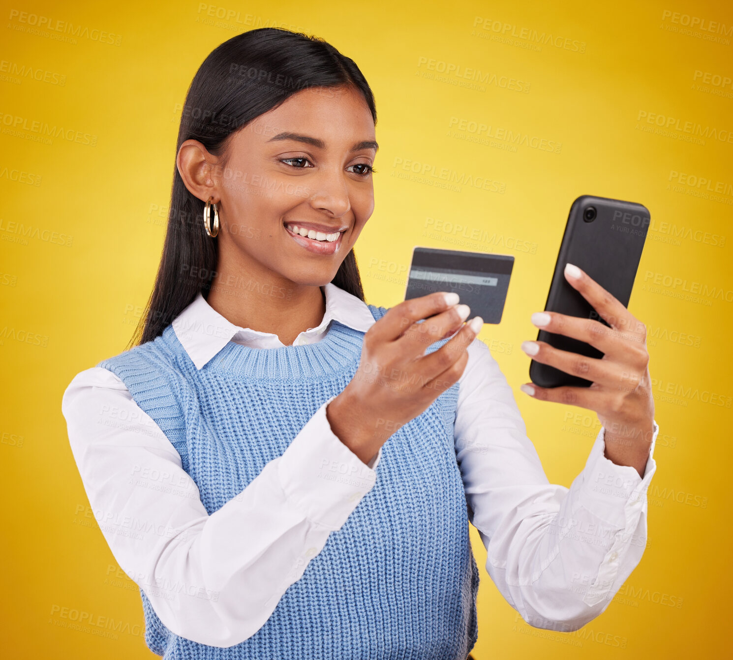 Buy stock photo Smile, phone and credit card, woman in studio for ecommerce or online shopping payment on yellow background. Technology, communication and mobile app happy girl checking internet banking and budget.