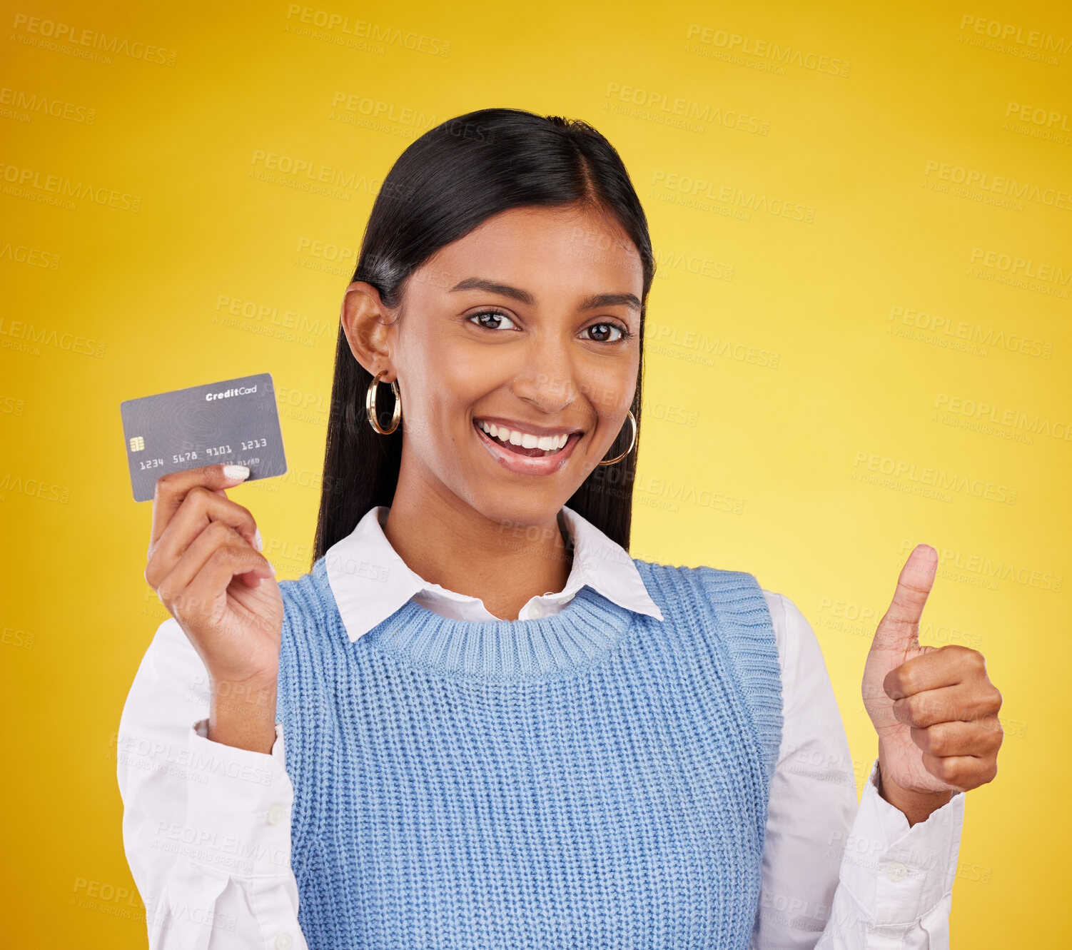 Buy stock photo Credit card, thumbs up and portrait of Indian woman on yellow studio for bank, investment and payment. Banking mockup, finance and happy girl with yes hand sign for budget, commerce and purchase