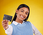 Credit card, portrait and Indian woman on yellow background for bank, investment and payment in studio. Banking mockup, finance and happy girl with plastic for budget, commerce and promotion purchase