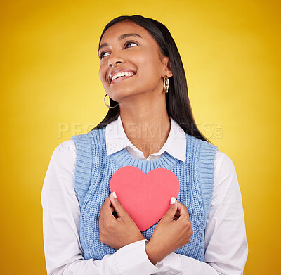 Buy stock photo Love, paper and heart with woman in studio for happy, support and romance. Valentines day, kindness and date with female and holding symbol on yellow background for health, happiness and hope mockup