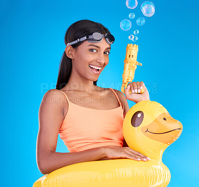 Buy stock photo Portrait, bubbles and rubber duck with a woman on a blue background in studio ready for summer swimming. Happy, vacation and goggles with an attractive young female looking excited to relax or swim