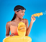 Bubbles, summer swimsuit and woman with bubble gun in a studio with fun and happiness. Isolated, blue background and happy female model with playful smile and swimming outfit for pool entertainment