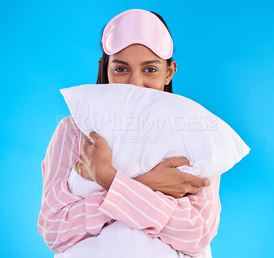 Buy stock photo Portrait, pillow and woman in pajamas, happy and ready for sleeping against isolated blue studio background. Face, female and person with sleepwear, eye mask and calm with happiness and cushion hug