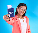 Happy woman, passport or ticket for travel, flight or USA documents against a blue studio background. Portrait of female business traveler smile holding international boarding pass or booking trip