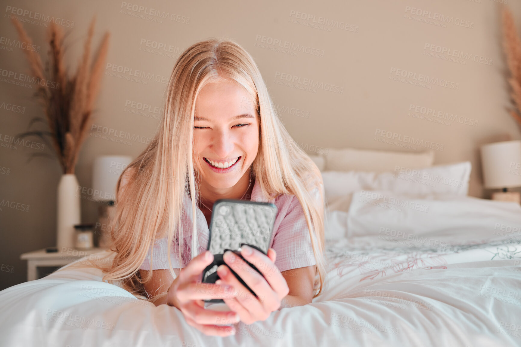 Buy stock photo Relax, smile or woman on bed, smartphone or typing for social media, connection or break. Female, girl or person with cellphone, mobile app or communication with network signal or chatting in bedroom