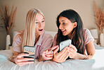 Wow, happy and women with a phone on a bed for social media, communication and notification. Shock, smile and friends reading news, message or online chat on a mobile during a sleepover together