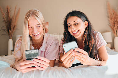 Buy stock photo Teen friends, smartphone and girl on bed, relax and smile on face, social media scroll and happiness at home. Technology, young people chat on internet with gen z and phone app with meme online