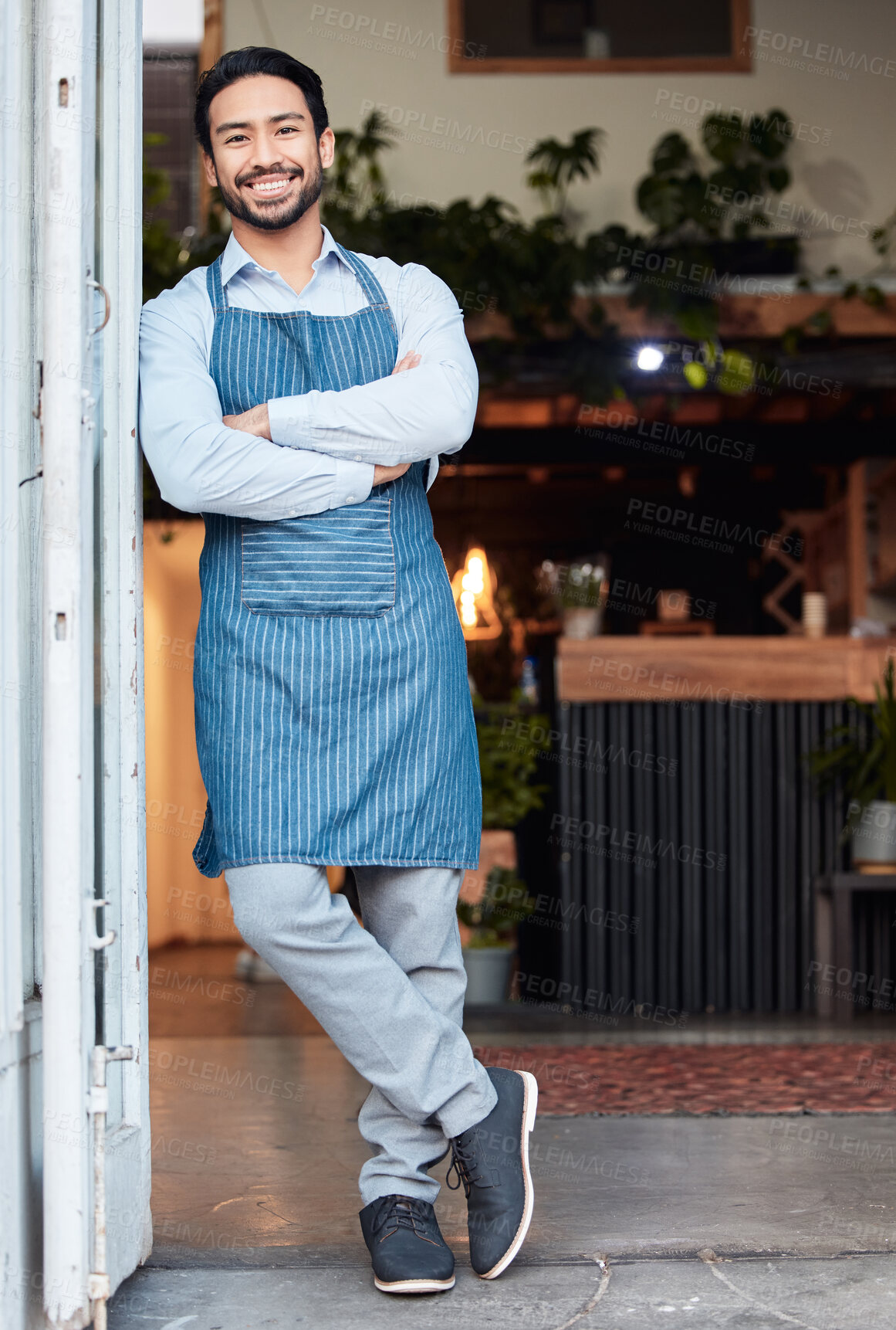 Buy stock photo Happy, arms crossed and portrait of an Asian man at a restaurant for a welcome, service and job at the door. Smile, working and a Japanese waiter at entrance of a cafe of coffee shop in the morning