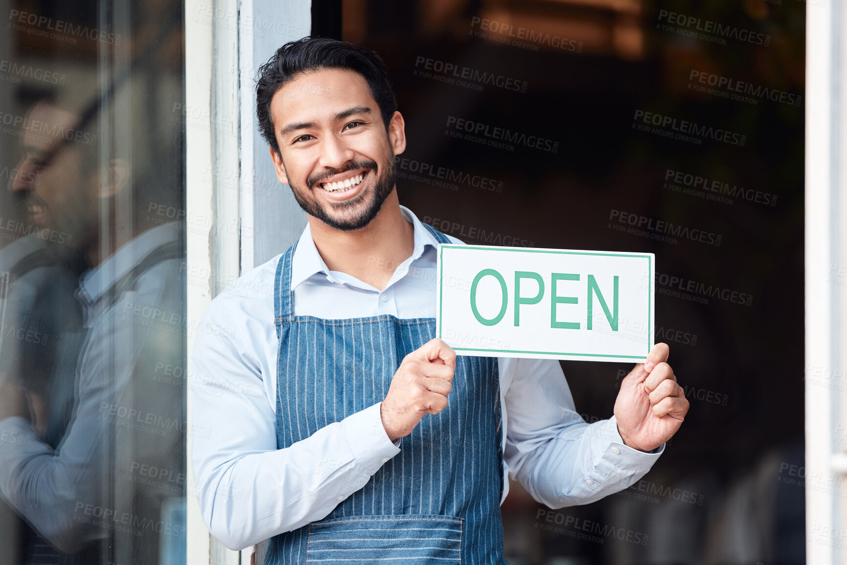 Buy stock photo Happy asian man, small business and portrait with open sign for service in coffee shop or restaurant. Male entrepreneur, manager or waiter holding billboard or poster for opening retail store or cafe