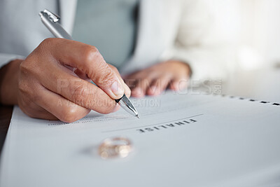 Buy stock photo Signature, ring and divorce paper of a woman at table with legal paperwork, anxiety or documents. Female person sign with pen on papers with wedding band jewellery for separation, cheating or mistake