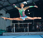 Sports, gymnastics and woman jumping with a ribbon in a professional gym or arena for training. Fitness, routine and female athlete gymnast doing a trick while practicing for competition or challenge