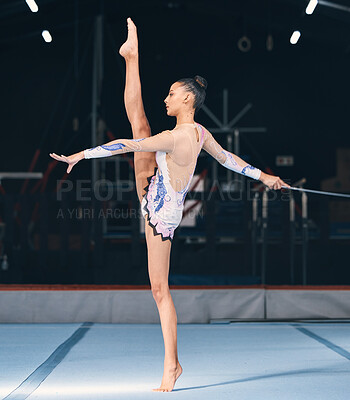 Ribbon, gymnastics and flexible woman in dance performance, balance legs and sports competition. Female, rhythmic movement and flexible dancing athlete, action and talent of creative concert in arena