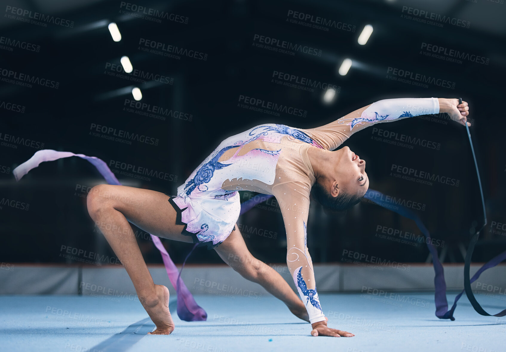 Buy stock photo Ribbon, gymnastics and flexible woman stretching in performance, dance training and sports competition. Female, rhythmic movement and dancing athlete, creative skill and talent for concert in arena 