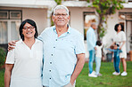 Outdoor, portrait and senior couple by their house embracing while bonding with their family. Love, smile and happy elderly man and woman in retirement standing in the backyard of their modern home.