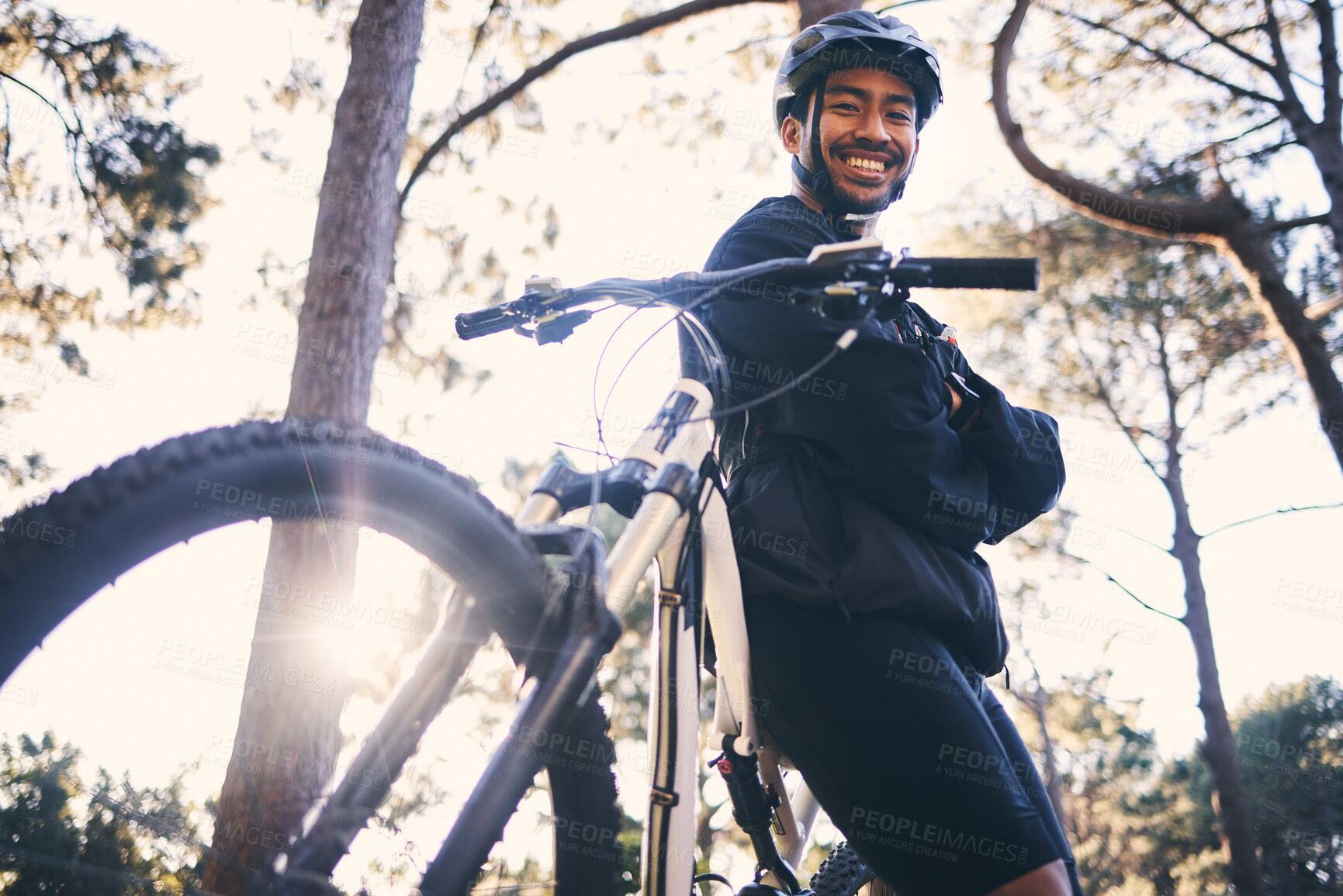 Buy stock photo Forest, fitness and portrait of cyclist with bicycle in nature with smile, adventure trail and health from below. Cycling, woods and man with mountain bike in trees for workout, motivation or energy.