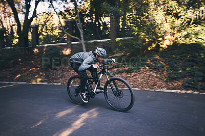 Buy stock photo Cycling, nature and relax with man on road for training, workout or cardio exercise. Adventure, extreme sports and speed with male cyclist on bike in forest park for performance, challenge or break