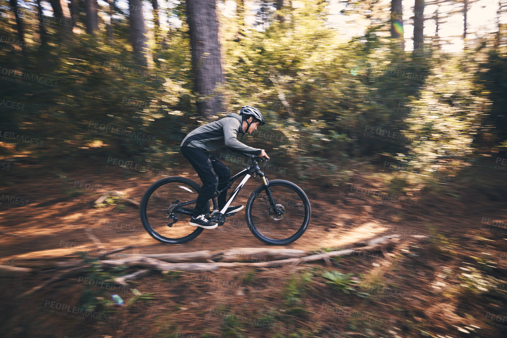 Buy stock photo Man, outdoor and cycling in nature for sports, exercise or training on a mountain bike with speed. Athlete male person on a bicycle for a fitness workout for energy in a forest with green trees