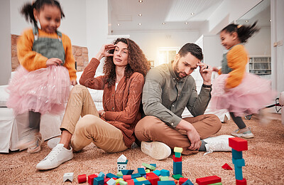 Buy stock photo Family, girl playing and parents with stress, frustrated or in living room with a headache or burnout. Mother, father or female child with toys, busy or fast speed in lounge, home or hyper active kid