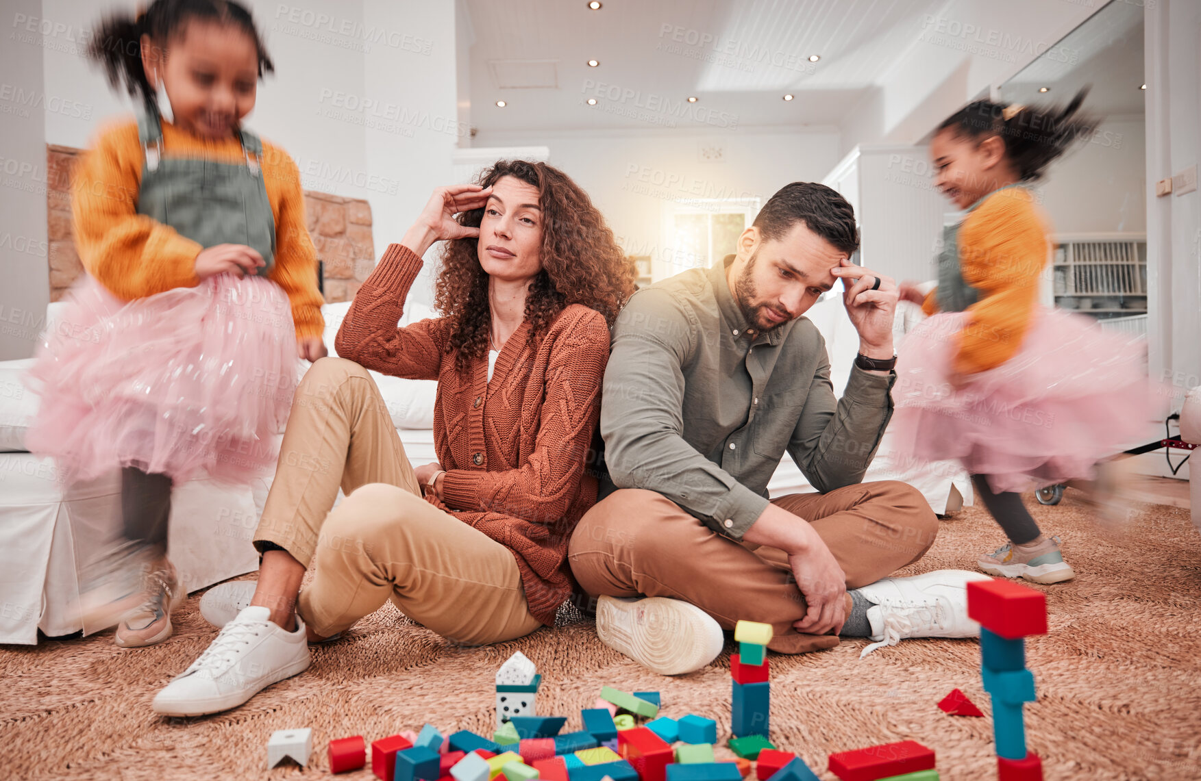 Buy stock photo Family, girl playing and parents with stress, frustrated or in living room with a headache or burnout. Mother, father or female child with toys, busy or fast speed in lounge, home or hyper active kid