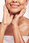 Hands, mouth and skin with a mature woman in studio for beauty, anti aging treatment or cosmetics. Skincare, facial and wellness with a senior female moisturizing her face for hydration closeup