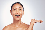 Wow, skincare and portrait of a woman with space for product placement isolated on a studio background. Advertising, shock and a mature model showing mockup for branding, beauty and cosmetics