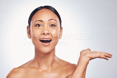 Buy stock photo Wow, skincare and portrait of a woman with space for product placement isolated on a studio background. Advertising, shock and a mature model showing mockup for branding, beauty and cosmetics