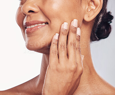 Buy stock photo Hand, mouth and facial with a mature woman in studio for skincare, anti aging treatment or cosmetics. Beauty, skin and wellness with a senior female moisturizing her face for hydration closeup
