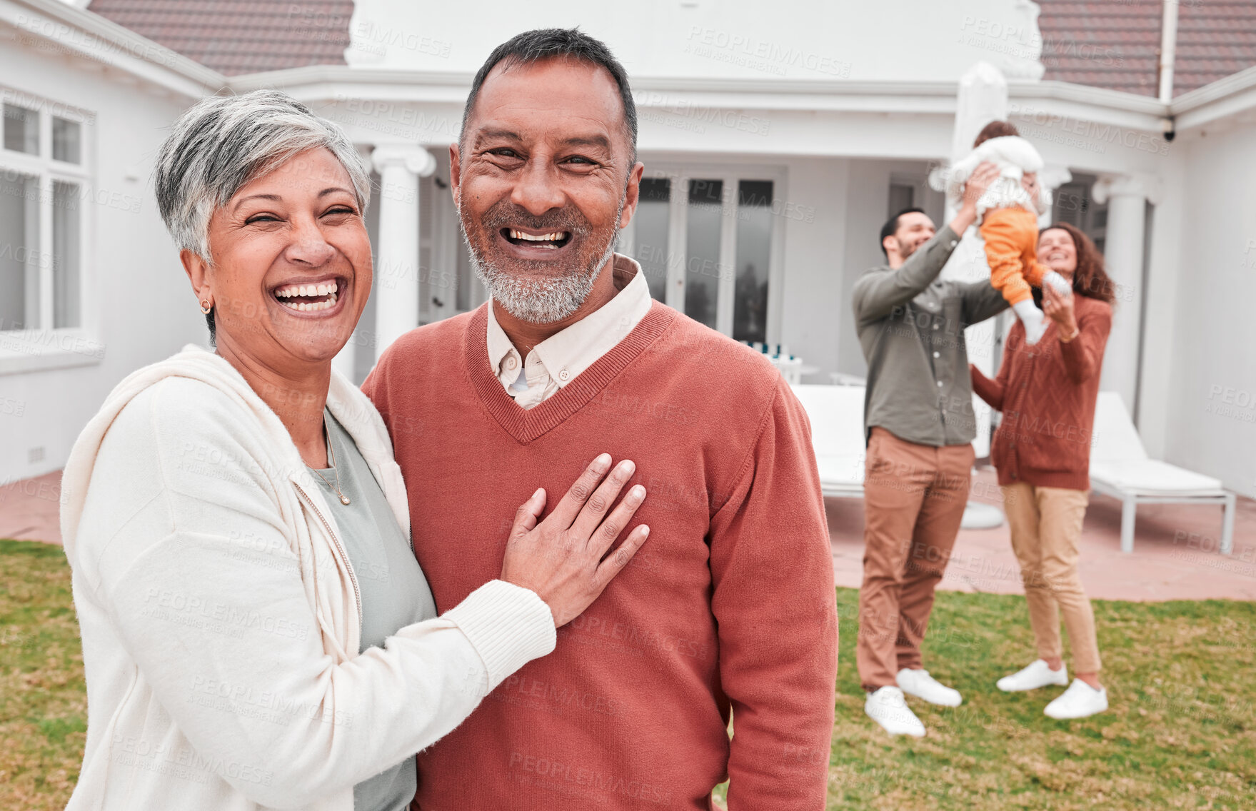Buy stock photo Happy, outdoor and portrait of senior couple standing in the yard of their modern family home. Happiness, smile and elderly man and woman in retirement with their children and grandchild by the house