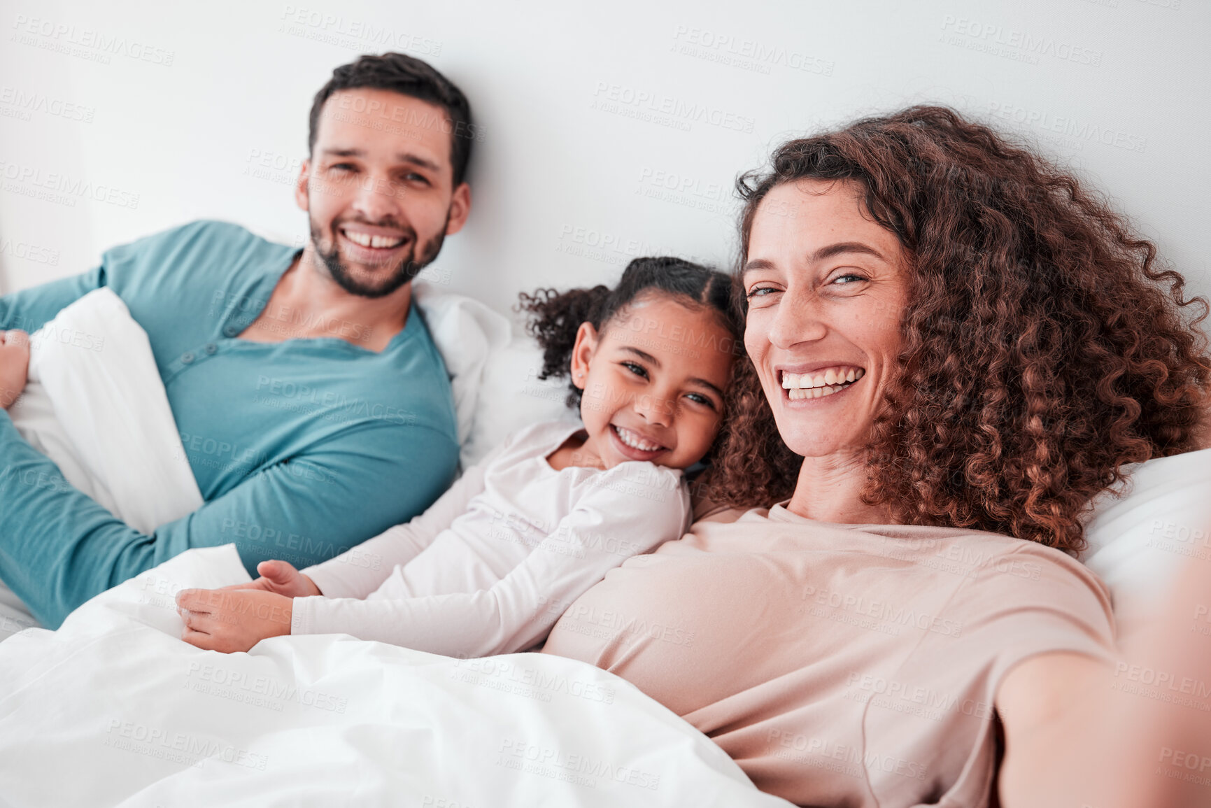 Buy stock photo Selfie, bedroom and portrait of parents with girl in bed relax for quality time, bonding and love in morning. Family home, face and happy mother, father and child smile for picture, post and memory