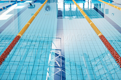 Buy stock photo Swimming, lane and water at an indoor pool for sports, recreation and weekend fun. Empty, training and a rows for competition, sport race or practice cardio for athletes or leisure activities