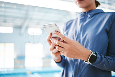 Buy stock photo Hands, phone and athlete texting at swimming pool for social media, web scrolling or online browsing after exercise. Swim sports, cellphone and woman typing on internet chat after workout or training