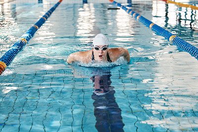 Sports, swimming pool or woman training in water for a race competition, exercise or cardio workout. Athlete swimmer, wellness or healthy girl exercising with fitness speed, motivation or resilience