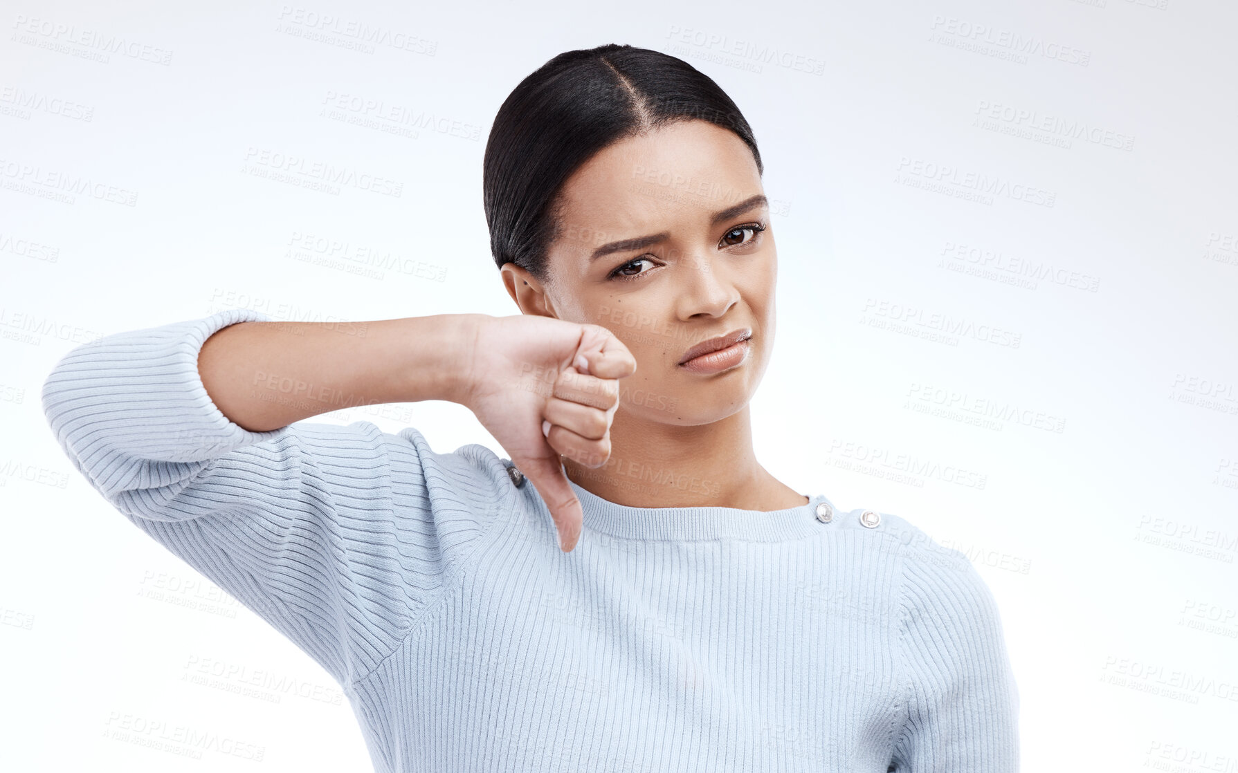 Buy stock photo Thumbs down, woman and portrait with no opinion and choice in a studio. Isolated, white background and bad review of a young female feeling disappointed from voting and emoji of fail hand sign 