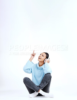 Buy stock photo Studio music, relax and woman point at radio sales promotion, advertising space or audio podcast mockup. Marketing commercial, headphones deal and sound streaming female listening on white background