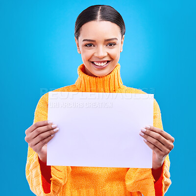 Buy stock photo Smile, mockup and poster with portrait of woman in studio for idea, branding and announcement. Promotion, space and paper with female and sign on blue background for news, logo and advertising