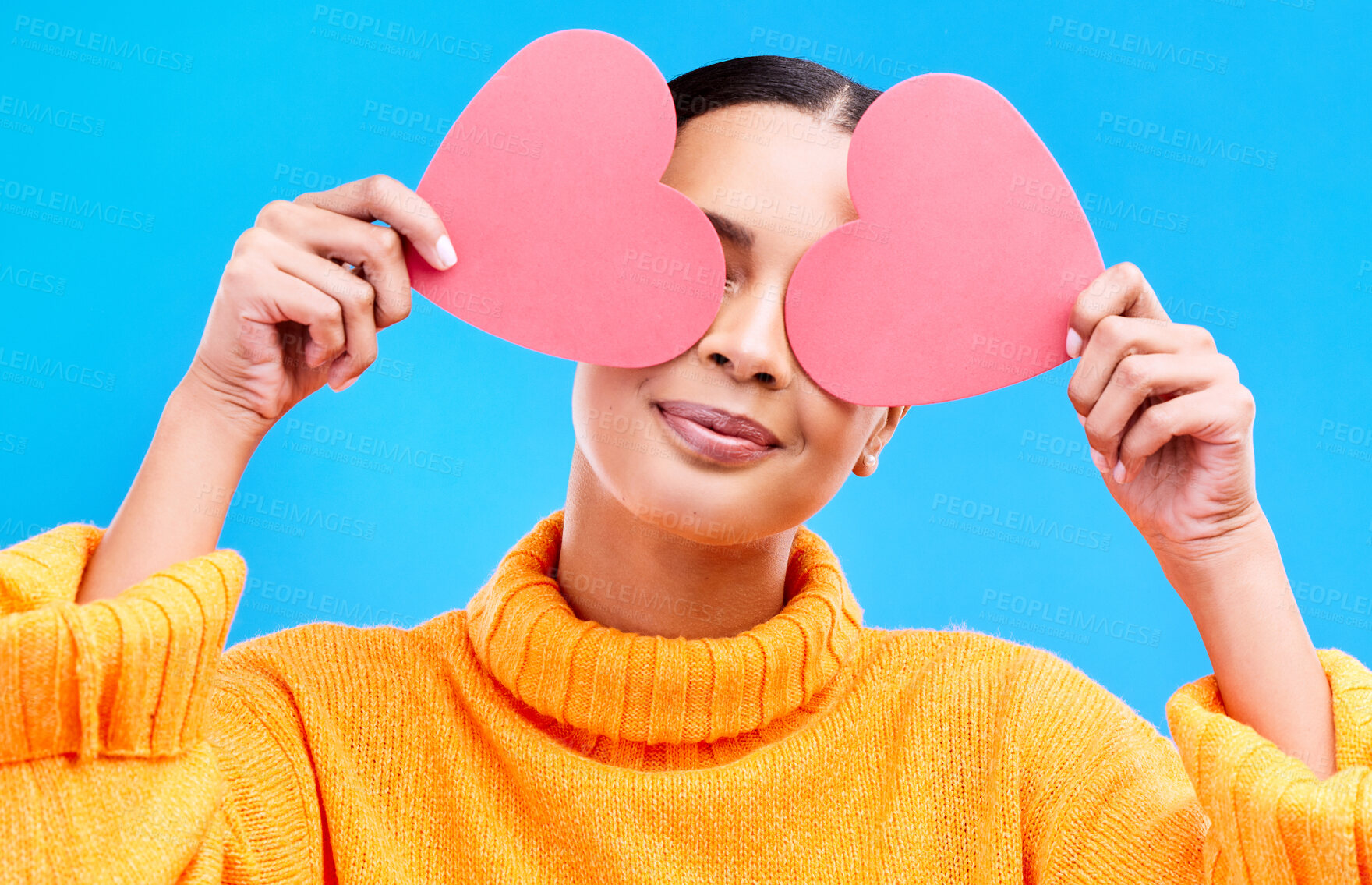 Buy stock photo Heart eyes, cover and woman smile with happiness and excited for love, valentines day or studio emoji. Happy, loving or person on isolated blue background, creative romance paper and show care symbol