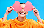 Heart eyes, studio and woman with happiness and excited about love holiday with emoji icon. Happy, smile and person with isolated blue background with loving and romance paper symbol to show care