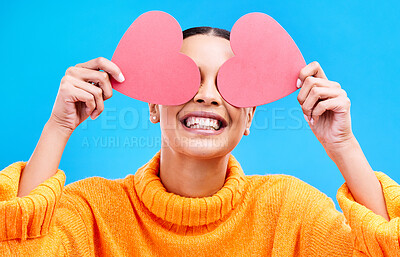 Buy stock photo Heart eyes, cover and woman with happiness and excited about love, valentines day or emoji. Happy, smile and person with isolated blue background, loving or creative romance paper symbol to show care