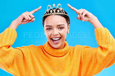 Buy stock photo Pointing, tiara or portrait of woman hands in studio celebration, princess or dress up party. Smile, beauty or fashion with female crown on blue background and excited for achievement, winner or prom