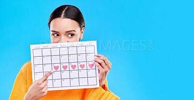 Buy stock photo Calendar, period and woman on blue background with heart for schedule, planning and menstruation in studio. Reminder mockup, monthly and eyes of girl with poster for date, weekly planner and cycle