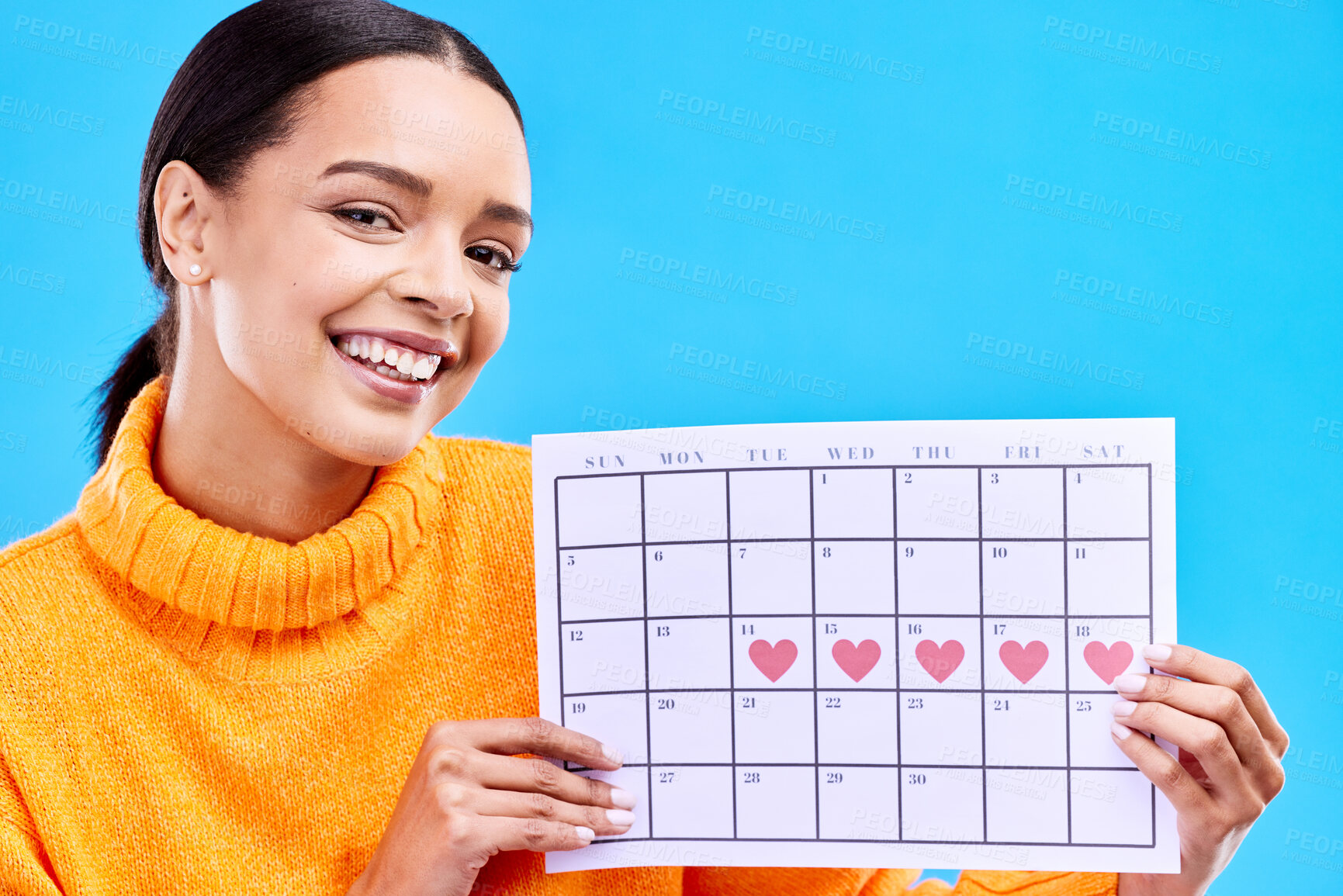 Buy stock photo Positive, portrait and woman with a calendar in a studio to track her menstrual or ovulation cycle. Happy, smile and face of a female model with a paper period chart isolated by a blue background.