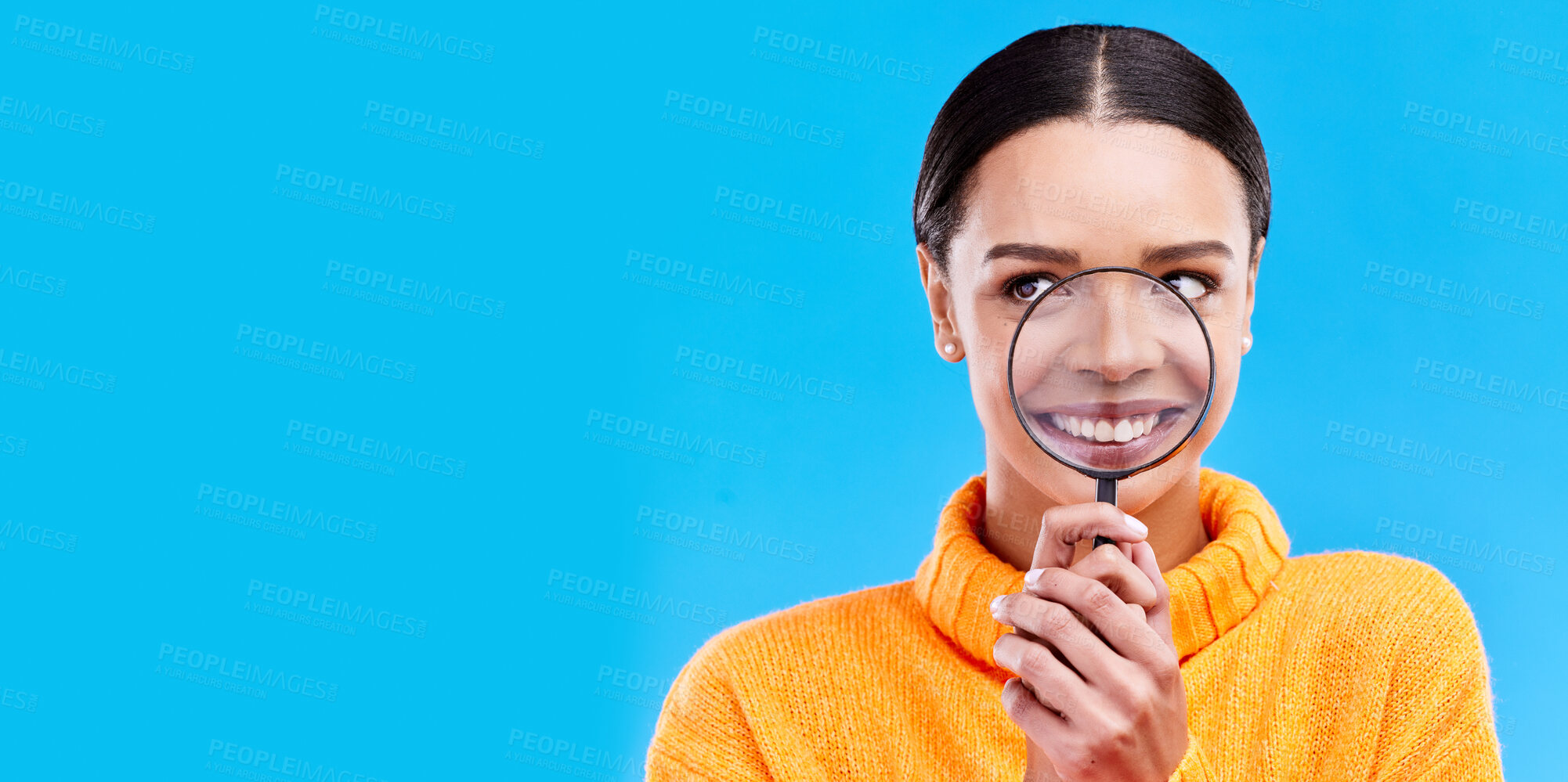 Buy stock photo Happy, smile and woman with magnifying glass in studio for zoom on her mouth for dental health. Happiness, excited and female model from Brazil with magnifier isolated by blue background with mockup.