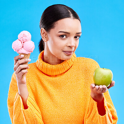 Buy stock photo Woman, ice cream and apple with choice in portrait for health, wellness and diet by blue background. Girl, model and decision for healthy fruits, junk food and balance in nutrition for body benefits